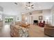 Spacious living room with vaulted ceilings, neutral paint, hardwood floors, and views of the dining room at 188 Morning Dew Ct, Winter Haven, FL 33884