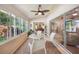 Bright sunroom with ceiling fan, sliding glass doors, neutral carpet, and views of the beautiful manicured garden at 188 Morning Dew Ct, Winter Haven, FL 33884