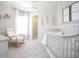 Cozy Bedroom room featuring chair, crib, carpet floors, natural light and cheerful decoration at 1906 Daystar Dr, Haines City, FL 33844