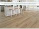 Durable vinyl plank flooring with neutral tones complements a modern kitchen and seating area at 1906 Daystar Dr, Haines City, FL 33844