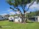 Large backyard with a mix of shade and sun, offering ample space for recreation and enjoying the outdoors at 2005 Blue Lake Dr, Lakeland, FL 33801