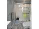 Bathroom showcasing a modern glass-enclosed shower, toilet and towel racks at 2005 Blue Lake Dr, Lakeland, FL 33801