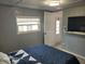 Cozy bedroom features a window, TV, and a blue and white quilt, perfect for relaxing at 2005 Blue Lake Dr, Lakeland, FL 33801