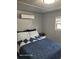 Bedroom showing the bed and an air conditioner unit at 2005 Blue Lake Dr, Lakeland, FL 33801