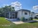 Charming single-story home with a screened-in porch and well-maintained landscaping at 2005 Blue Lake Dr, Lakeland, FL 33801
