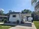 Charming single-story home with a carport, well-maintained lawn and mature landscaping under a bright blue sky at 2005 Blue Lake Dr, Lakeland, FL 33801