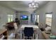 Living room with wood-look floors, ample seating, and natural light from multiple windows at 2005 Blue Lake Dr, Lakeland, FL 33801
