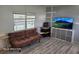 Cozy living room featuring wood-look floors and comfortable seating with a television at 2005 Blue Lake Dr, Lakeland, FL 33801