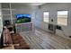 Bright living room featuring wood-look floors, comfortable seating, and a television at 2005 Blue Lake Dr, Lakeland, FL 33801