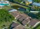 High angle of townhome roofs, a community pond, and landscaping at 2025 Sylvester Rd # P4, Lakeland, FL 33803