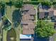 Aerial view of townhome roofs, showing landscaping, parking, and a community pond at 2025 Sylvester Rd # P4, Lakeland, FL 33803