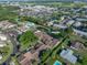 A high angle view shows a townhome complex with a pond, community pool, and tennis courts at 2025 Sylvester Rd # P4, Lakeland, FL 33803