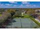 Aerial view showcases tennis courts, landscaping, and community amenities under a blue sky at 2025 Sylvester Rd # P4, Lakeland, FL 33803