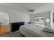 Comfortable bedroom with ceiling fan and sliding glass doors to a screened patio and backyard at 2025 Sylvester Rd # P4, Lakeland, FL 33803