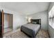 Bedroom featuring a full bed with black headboard and a double door closet at 2025 Sylvester Rd # P4, Lakeland, FL 33803