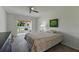 Cozy bedroom with ceiling fan and sliding glass doors to a screened patio and backyard at 2025 Sylvester Rd # P4, Lakeland, FL 33803