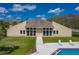 Front exterior view of the community clubhouse with a manicured lawn, pool, and inviting entrance at 2025 Sylvester Rd # P4, Lakeland, FL 33803