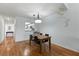 Open-concept dining area with wood floors connects to kitchen at 2025 Sylvester Rd # P4, Lakeland, FL 33803