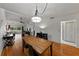 Open-concept dining area with wood floors connects to backyard and bathroom at 2025 Sylvester Rd # P4, Lakeland, FL 33803
