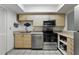 Bright kitchen features stainless steel appliances, light wood cabinets, and neutral countertops at 2025 Sylvester Rd # P4, Lakeland, FL 33803