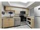 Bright kitchen features stainless steel appliances, light wood cabinets, and neutral countertops at 2025 Sylvester Rd # P4, Lakeland, FL 33803