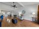 Bright open-concept living room featuring wood floors, vaulted ceiling, comfortable seating, and dining area at 2025 Sylvester Rd # P4, Lakeland, FL 33803
