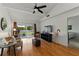 Bright living room featuring wood floors, ceiling fan, comfortable seating, and sliding glass doors to outdoor area at 2025 Sylvester Rd # P4, Lakeland, FL 33803