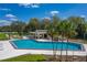 Beautiful community pool with palm trees and covered lounge area for relaxation at 2025 Sylvester Rd # P4, Lakeland, FL 33803