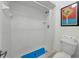 A well-lit tiled shower stall with a blue non-slip mat, toilet, and a novelty X-ING sign at 2025 Sylvester Rd # P4, Lakeland, FL 33803