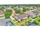 Aerial view of a home featuring a screened porch, fenced yard, and proximity to a neighborhood with mature trees at 2025 Viewpoint Landings Rd, Lakeland, FL 33810