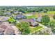 Expansive aerial view showcasing a home with a private pool and well-manicured lawn in a serene neighborhood at 2025 Viewpoint Landings Rd, Lakeland, FL 33810