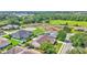 Scenic aerial shot of a neighborhood home with a screened pool and lush backyard in a green, suburban setting at 2025 Viewpoint Landings Rd, Lakeland, FL 33810