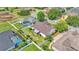 An aerial view of a home's backyard featuring a screened enclosure and a white fence enclosing the property at 2025 Viewpoint Landings Rd, Lakeland, FL 33810