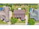Aerial view of property showcasing roof, landscaping, and proximity to neighboring homes with pools at 2025 Viewpoint Landings Rd, Lakeland, FL 33810