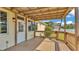 Covered back porch featuring wood flooring and railings with a view of the backyard at 2025 Viewpoint Landings Rd, Lakeland, FL 33810