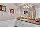 Bathroom has a spacious vanity with white cabinets and a large mirror under decorative lighting at 2025 Viewpoint Landings Rd, Lakeland, FL 33810