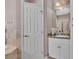 Comfortable bathroom with a sink vanity, a shower with glass doors, and tile backsplash at 2025 Viewpoint Landings Rd, Lakeland, FL 33810