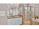Well-lit bathroom featuring vanity and glass-enclosed shower with tiled walls and shower fixture at 2025 Viewpoint Landings Rd, Lakeland, FL 33810