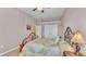 Relaxing bedroom with an elegant iron bed frame, soft carpet, and generous closet space at 2025 Viewpoint Landings Rd, Lakeland, FL 33810