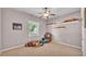 Neutral bedroom with plush carpeting, ceiling fan, and shelving, creating a cozy atmosphere at 2025 Viewpoint Landings Rd, Lakeland, FL 33810