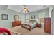 Relaxing bedroom featuring a ceiling fan, two windows, and complementing furniture in a carpeted space at 2025 Viewpoint Landings Rd, Lakeland, FL 33810