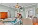 Inviting bedroom with ceiling fan, dresser, and door to a sunroom, all in a carpeted space at 2025 Viewpoint Landings Rd, Lakeland, FL 33810