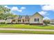 Charming home with a welcoming front porch, complete with rocking chairs, and a beautifully landscaped front yard at 2025 Viewpoint Landings Rd, Lakeland, FL 33810