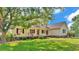 Inviting home featuring a cozy porch with swing and rocking chairs, surrounded by lush greenery and manicured landscaping at 2025 Viewpoint Landings Rd, Lakeland, FL 33810
