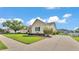 Side view of a home with a long driveway, well-manicured lawn, and mature landscaping at 2025 Viewpoint Landings Rd, Lakeland, FL 33810