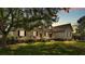 Charming home featuring a lush front lawn, mature trees, and a welcoming front porch at 2025 Viewpoint Landings Rd, Lakeland, FL 33810