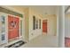 Covered front porch featuring a red front door, black accents, and tile flooring at 2025 Viewpoint Landings Rd, Lakeland, FL 33810