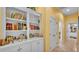 Hallway featuring decorative shelving filled with books and decorative models of houses at 2025 Viewpoint Landings Rd, Lakeland, FL 33810