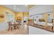 Eat-in kitchen boasts white cabinets, matching appliances, and tile flooring at 2025 Viewpoint Landings Rd, Lakeland, FL 33810