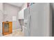 Bright laundry area with white cabinets and tile floor plus a convenient refrigerator and wooden storage cabinet at 2025 Viewpoint Landings Rd, Lakeland, FL 33810